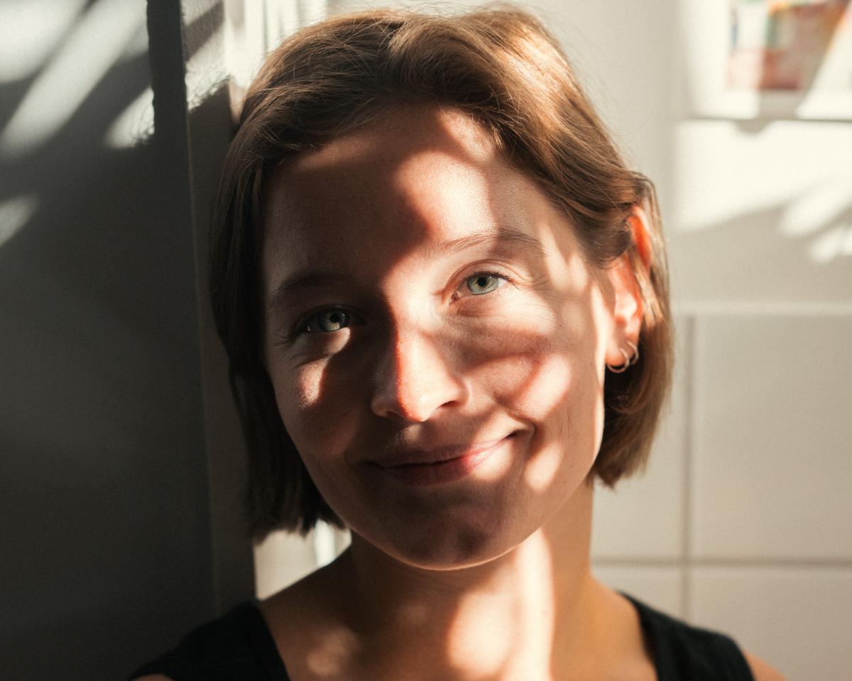 Face of woman in sunlight shadows